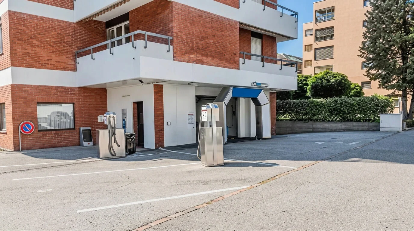 Due stazioni di rifornimento self-service in un parcheggio vuoto accanto a un edificio in mattoni. Due stazioni di rifornimento self-service in un parcheggio vuoto accanto a un edificio in mattoni.